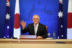 Australian Prime Minister Scott Morrison attends a virtual summit with Japanese Prime Minister Kishida Fumio in Canberra on January 6, 2022, to mark the opening of a new chapter of defence and security cooperation between the two countries, with the signing of a Reciprocal Access Agreement. 