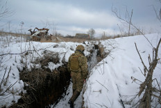 A service member of the Ukrainian armed forces walks at a combat position near the line of separation from Russian-backed rebels in Luhansk Region, Ukraine, on Feb. 6, 2022. 