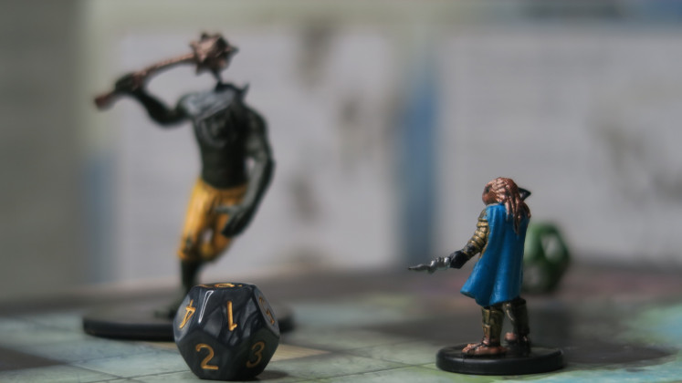 What the players need: Two miniatures, a dice and an adventure grid owned by Indra Aziz are used to play 