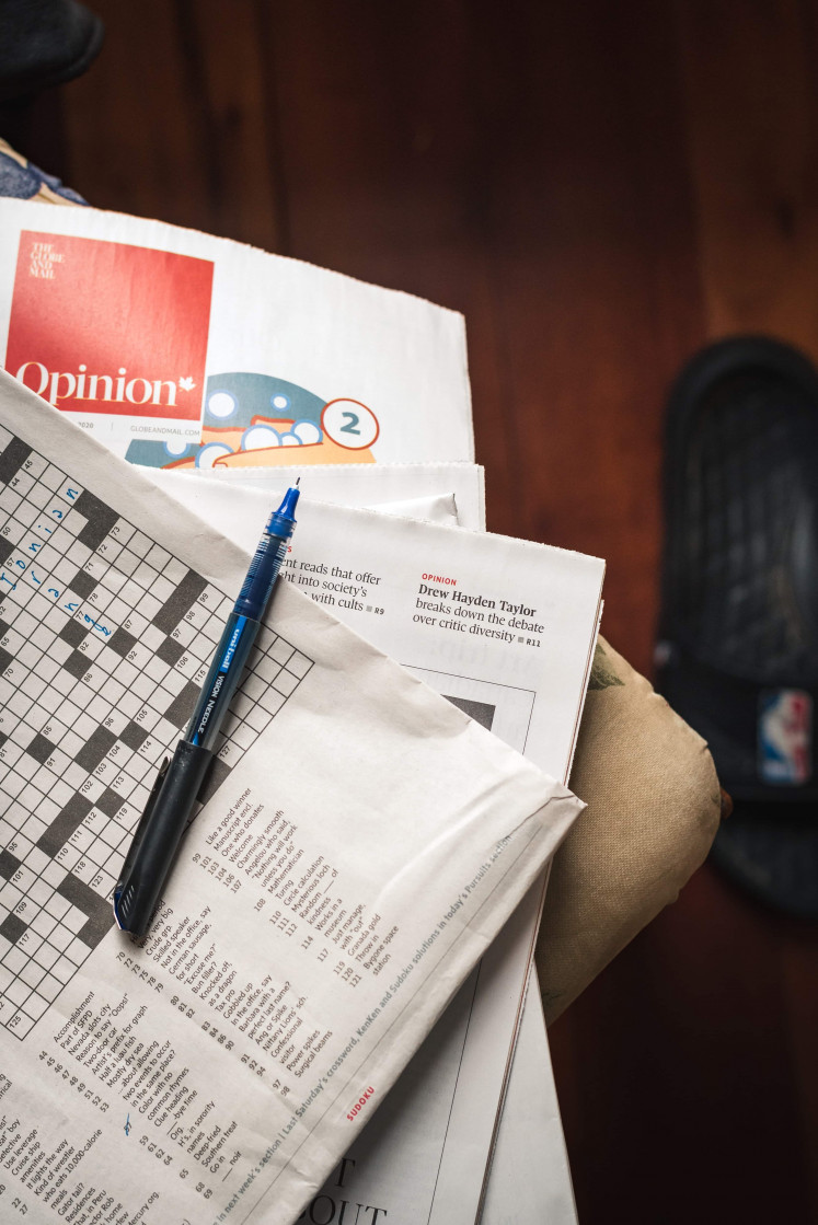 Classic: A crossword in the Canadian newspaper 'The Globe' and 'Mail' is pictured. The origins of word games like 'Scrabble' and 'Wordle' can be traced back to their similarities with crosswords. (Unsplash/Bannon Morrissy) 