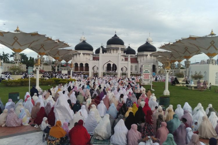 On a sacred day: Crowds at last year's Eid al Adha prayers in the Baiturrahman Mosque in Banda Aceh. The city briefly had the country's tightest lockdown rules outside of Java and Bali, but health protocols were often unheeded (Daspriani Y. Zamzami for Kompas.com)