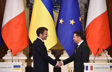 Ukrainian President Volodymyr Zelensky (right) and French President Emmanuel Macron shake hands after a press conference following their meeting in Kyiv on February 8, 2022. Ukraine's President Volodymyr Zelensky said on February 8, 2022, he expected to hold a summit soon with the leaders of Russia, France and Germany, after meeting French leader Emmanuel Macron in Kyiv. 