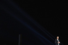Elon Musk gestures as he speaks during a press conference at SpaceX's Starbase facility near Boca Chica Village in South Texas on February 10, 2022. Billionaire entrepreneur Elon Musk delivered an eagerly-awaited update on SpaceX's Starship, a prototype rocket the company is developing for crewed interplanetary exploration.