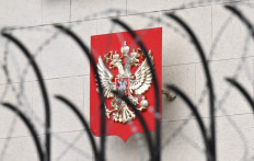 This picture shows the Russian coat of arms set on the embassy in Kyiv and seen through barbed wire on February 12, 2022. Russia said February 12, 2022, it has pulled some of its diplomatic staff out of Ukraine for fear of 