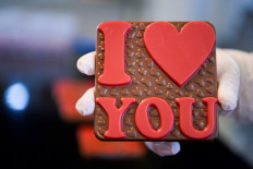 Be my Valentine: A worker holds up a freshly made chocolate at the Amel handcrafted chocolate factory near Pristina, Kosovo, on Feb. 12, ahead of Valentine’s Day.
