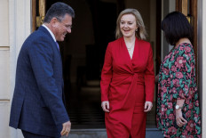 Britain's Foreign Secretary Liz Truss (center) welcomes European Commission vice president Maros Sefcovic (left) upon his arrival for a meeting on the Northern Ireland Protocol, at the No 1 Carlton Gardens, in London, on February 11, 2022. 