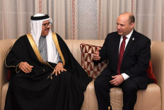 A handout picture obtained from the Israeli Government Press Office (GPO) on February 14, 2022 shows Bahrain's Minister of Foreign Affairs Abdullatif bin Rashid Al-Zayani welcoming Israeli Prime Minister Naftali Bennett in Manama's airport. Bennett arrived in Bahrain today for the first-ever official visit by an Israeli head of government to the Gulf state, an AFP reporter said.