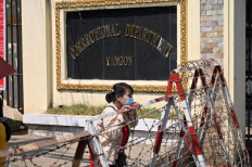 Long time no see: A woman waits for the release of prisoners in front of the Insein prison in Yangon, Myanmar, on Feb. 12. Human rights groups estimate about 9,000 people remain in detention since the military overthrew the democratically elected government in Myanmar on Feb. 1, 2021.