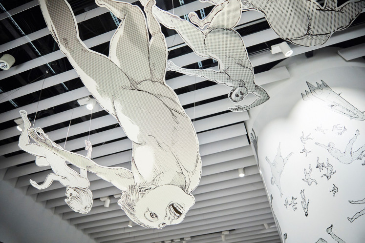 Raining bodies: Three-dimensional Titans appear to fall from the sky in the exhibition, offering visitors a sense of the dystopian world. (Courtesy of Marina Bay Sands)