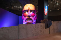 Giant glance: A “life-sized” rendering of the Colossus Titan takes a peek over the walls. (Courtesy of Marina Bay Sands)