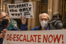 People hold signs and participate in a protest in Grand Central Station in the borough of Manhattan against war in Ukraine on February 19, 2022 in New York City. A coalition of antiwar, environmental, free speech, human rights and veterans groups joined forces to demonstrate against US/NATO war with Russia in Ukraine. 