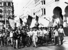  In this file photo taken on May 13, 1958, youths waving French flags roam the streets of Algiers, on their way to the Forum square and the government palace stormed by demonstrators, during the Algerian war. The Evian Accords were signed on March 18, 1962, between France and the Provisional Government of the Algerian Republic (GPRA), the government-in-exile of the Algerian National Liberation Front (FLN), ending the Algerian War of 1954-1962 and pathing the way for Algeria's Independence from France.
