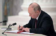 Russian President Vladimir Putin signs documents, including a decree recognising two Russian-backed breakaway regions in eastern Ukraine as independent, during a ceremony at the Kremlin in Moscow on February 21, 2022. President Vladimir Putin said on February 21, 2022, he would make a decision 