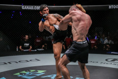 Destructive power: Aung La N Sang of Myanmar (left) lands a left high kick to his opponent in the ONE Championship circle. 