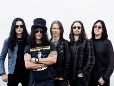 Keep rockin': Even though guitar music is not front and center at the moment, Slash (second left) believes there's a bigger market for live rock 'n roll than anything else. (Courtesy of Ross Halfin/Ross Halfin)