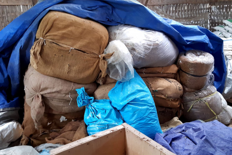 Tough market: Fifteen tons of tobacco are stored in sacks near the homes of Ngawi farmers. (Project Multatuli/Nurika Manan)