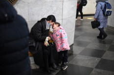 A mother and her child play as they take shelter in a station in central Kyiv on February 24, 2022. Russian President launched a full-scale invasion of Ukraine on February 24, 2022, killing dozens and forcing hundreds to flee for their lives in the pro-Western neighbour.