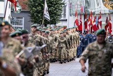 Military personnell carry the Danish flag (Dannebrog) as they parade through the city of Aalborg, Denmark, during the Flag Day for Denmark's emissaries, on September 5, 2021. The Flag Day honours people who are or have been sent on a mission by Denmark.
