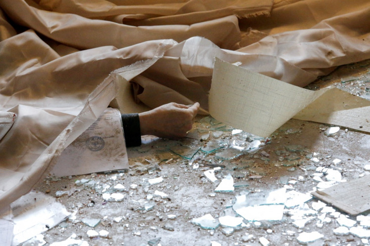 A view shows the body of a school employee, who according to locals was killed by recent shelling, in the separatist-controlled town of Horlivka (Gorlovka) in the Donetsk region, Ukraine February 25, 2022. 