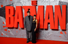 British actor Robert Pattinson (left) and US actress Zoe Kravitz pose on the red carpet upon arrival for a special screening for the movie 