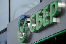 The logo of Russia's state-owned bank Sberbank (reading 'Sber') is seen on one of its offices in Moscow on April 1, 2022. 