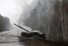 Smoke rises from a Russian tank destroyed by Ukrainian forces on the side of a road in the Lugansk region on Feb. 26. 