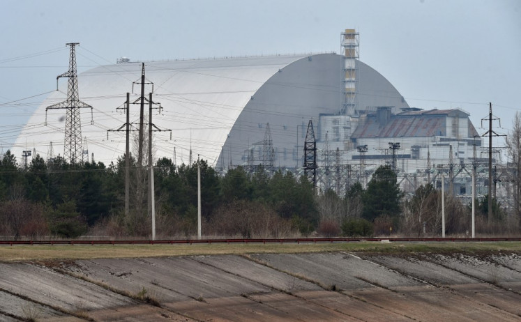 A file picture taken on April 13, 2021 shows the giant protective dome built over the sarcophagus covering the destroyed fourth reactor of the Chernobyl Nuclear Power Plant ahead of the upcoming 35th anniversary of the Chernobyl nuclear disaster. Ukraine announced on February 24 that Russian forces had captured the Chernobyl nuclear power plant after a 