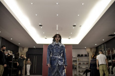 A model presents a creation for Dior Fall-Winter 2022-2023 collection fashion show during a fitting session at Christian Dior's fashion house in Paris on February 28, 2022.