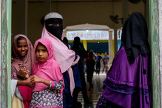 Rohingya refugees look on in the compounds of a mosque following their arrival by boat in Bireuen, Aceh province on March 6.