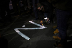 A protester paints the 'Z' sign on a street, in reference to Russian tanks marked with the letter, during a rally organised by Serbian right-wing organisations in support of Russian invasion in Ukraine, in Belgrade March 4, 2022. Around a thousand Serbian ultra nationalist supporters marched in Belgrade in support of the Russian invasion of Ukraine.