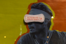 Now or never: A sanitary napkin bearing the sentence "Investigation for endometriosis now" is stuck on an ad at a bus stop in Madrid, Spain, on March 8, 2020 during a demonstration marking International Women's Day.