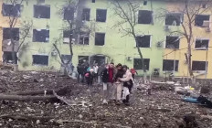 In this video grab from a handout footage taken and released by the the National Police of Ukraine on March 9, 2022, people are helped out of a damaged building of a children's hospital following a Russian air strike in the southeastern city of Mariupol. International leaders and Ukraine accused Russia of a 