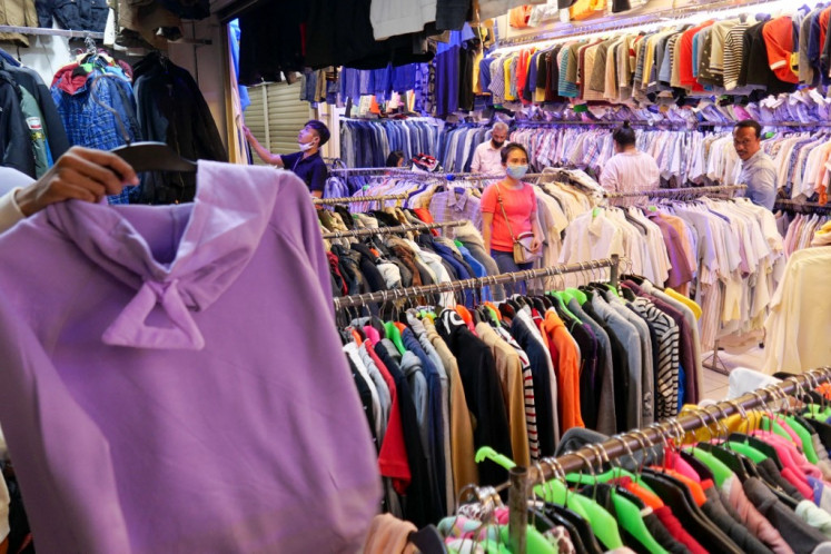Customers browse for clothes at a shop in Jakarta on June 9, 2020.
