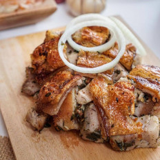 Crackling delight: The Philippines' play on the Italian roast pork dish, porchetta is a savory hit at SILOG+, best served with the restaurant's namesake signature garlic rice. (Instagram/SILOG+)