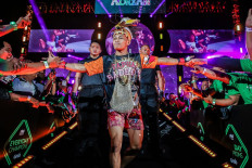 Indonesian MMA fighter Adrian Mattheis greets fans as he walks into the Circle. “Papua Badboy” will face fifth-ranked opponent Alex Silva in a strawweight bout on Friday. 