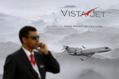 In this file photo taken on May 24, 2016 A pilot talks on his mobile phone at the stand of the Swiss private business jet charter VistaJet during the European Business Aviation Convention & Exhibition (EBACE) in Geneva.