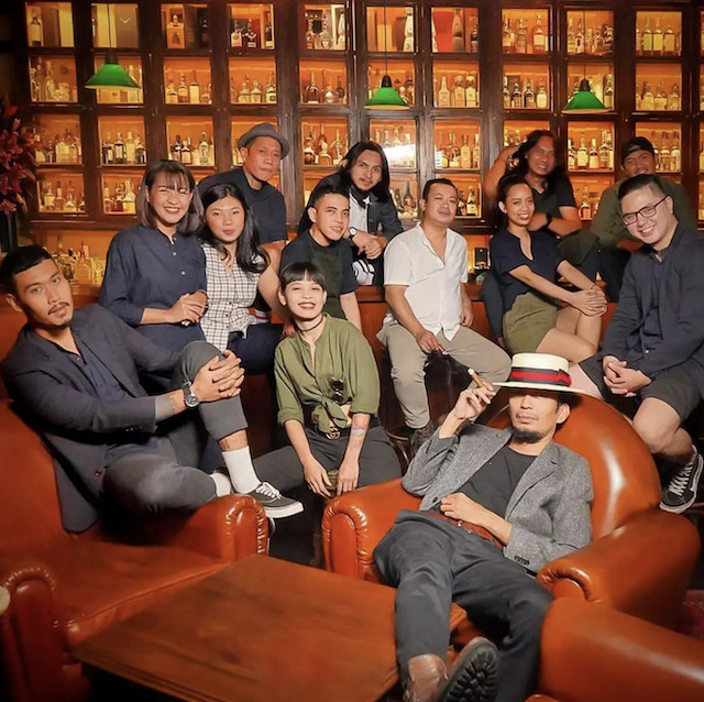 Come drink with us: Kiki Moka (sitting, wearing a hat) with The Cocktail Club's staff. The bar, located in the Senopati district in Jakarta, is currently his main base as a bartender. (Photo Courtesy of Kiki Moka)