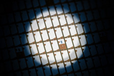 A new type of 300 millimeter wafer with semiconductor chips of German manufacturer Bosch is seen in Dresden, eastern Germany, on May 31, 2021.