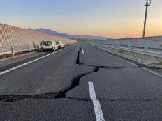 This handout picture taken and released on March 17, 2022 by NEXCO East Nippon Expressway Company shows cracks on a damaged road between Kunimi IC and Shiroishi IC on the Tohoku Expressway (down line) in Shiroishi, Miyagi prefecture, after a 7.3-magnitude earthquake jolted eastern Japan the night before. 