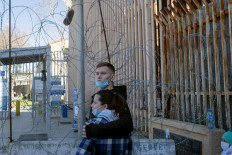Sasha and Julia, from Ukraine, wait for US authorities to let them in at San Ysidro Crossing port in Tijuana, Baja California state, Mexico, on March 12, 2022. During the past days citizens mainly from Ukraine, Russia, and Belarus, have been seen at the San Ysidro crossing port seeking for asylum in the United States.
