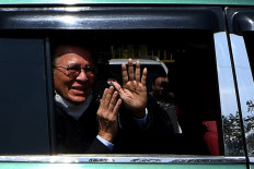 Former Cambodia National Rescue Party (CNRP) leader Kem Sokha waves to people as he departs the Phnom Penh municipal court on February 12, 2020. Sokha is currently on trial on treason charges, in a case decried by his family as a 