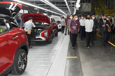 President Joko Widodo (second right) visits a Hyundai factory that produces the Ionic 5 electric car model on March 16, 2022 in Bekasi, West Java, in this handout photo from the State Palace released on March 17.