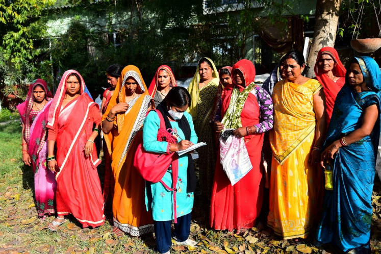Local coverage: Khabar Lahariya managing editor and reporter Meera Devi (center) speaks to village women on March 11 while reporting in Banda district, Uttar Pradesh state, India.