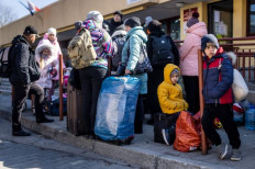 Safe haven: Refugees from Ukraine wait for further transportation at the railway station in Przemysl, Poland on Thursday. More than 3 million Ukrainians have fled across the border, mostly women and children, according to the United Nations. 