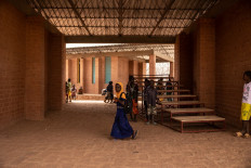 A girl walks at the Village-Opera school, designed by Architect Diebedo Francis Kere, in Laongo, on March 16, 2022.