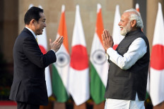 Japan's Prime Minister Fumio Kishida (left) and his Indian counterpart Narendra Modi gesture as they pose for pictures before their meeting at the lawns of the Hyderabad House in New Delhi on March 19, 2022. Kishida arrived in India on March 19 with officials in Tokyo predicting 