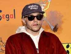 US actor-comedian Pete Davidson smokes as he arrives for Tubi's The Freak Brothers experience at Fred Segal in Los Angeles on December 6, 2021. 