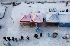 Residents queue to undergo nucleic acid tests for the Covid-19 coronavirus in Jilin in China's northeastern Jilin province on March 15, 2022. 
