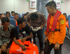 This handout photo from Search and Rescue (SAR) team and taken on March 19, 2022 and released on March 20, 2022 shows members of Search and Rescue identifying survivors during a rescue operation at sea in North Sumatra water where two people died and 26 others are missing after a ferry carrying dozens of migrants sank off the coast of Indonesia. 