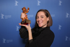 In this file photo taken on February 16, 2022 Spanish director and screenwriter Carla Simon poses during a photo call after being awarded the Golden Bear for Best Film award for the film 'Alcarras' after the awards ceremony of the 72nd Berlinale Film Festival in Berlin.